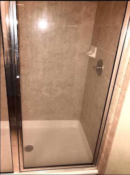 Modern shower enclosure featuring a tiled interior, chrome fixtures, and a clear glass door. Relevant for home improvement or bathroom design discussions.