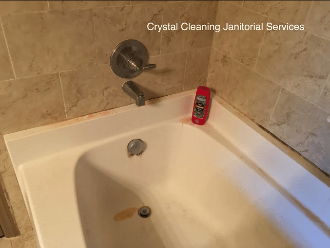 Dirty bathtub with soap residue and staining, showcasing the need for cleaning services by Crystal Cleaning Janitorial Services.