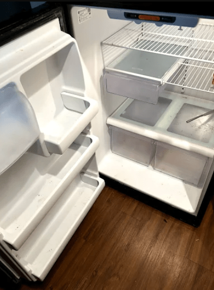 Empty refrigerator with some shelves and drawers visible, highlighting its clean, unfilled interior. Relevant for discussions about food storage or appliance maintenance.